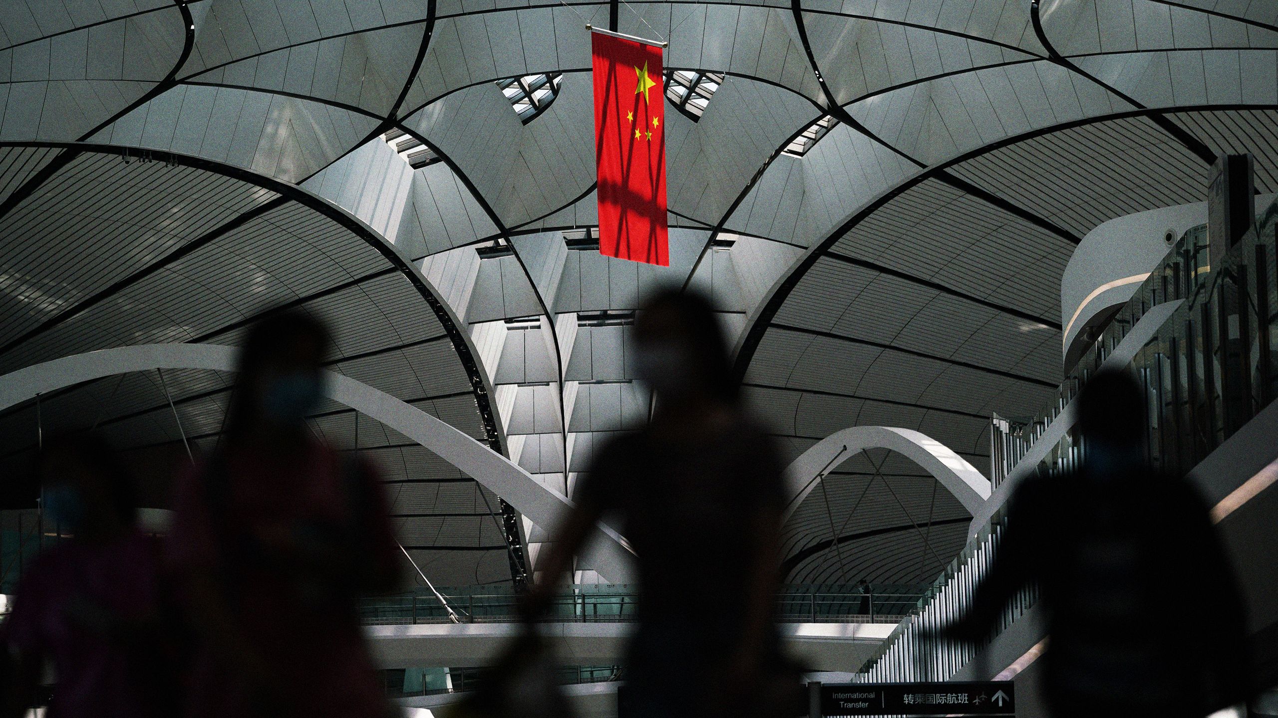 People wearing face masks at Beijing Daxing International Airport during the COVID-19 pandemic. 