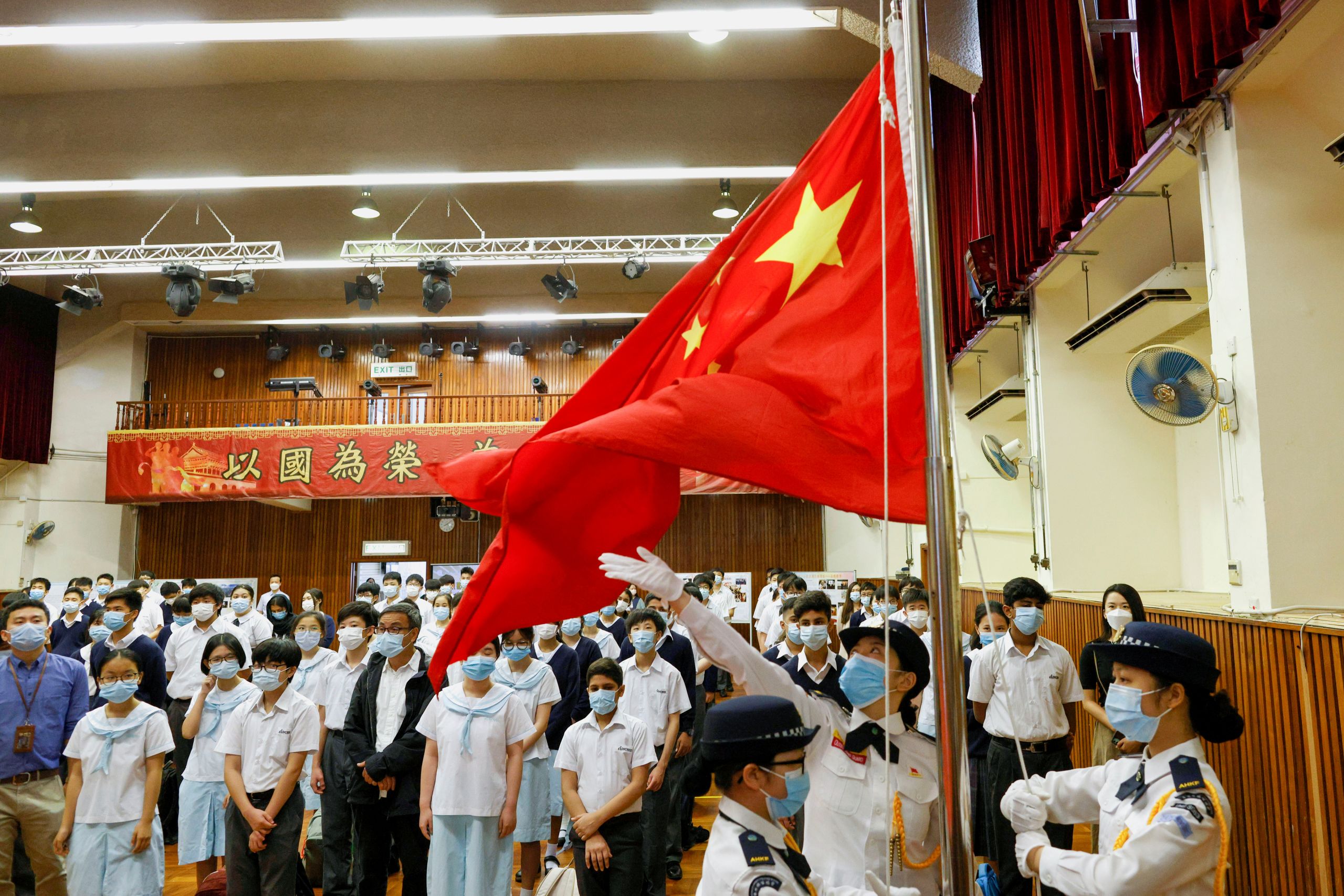 Students attend a flag raising ceremony during the morning assembly, ahead of National Security Education Day at a secondary school.