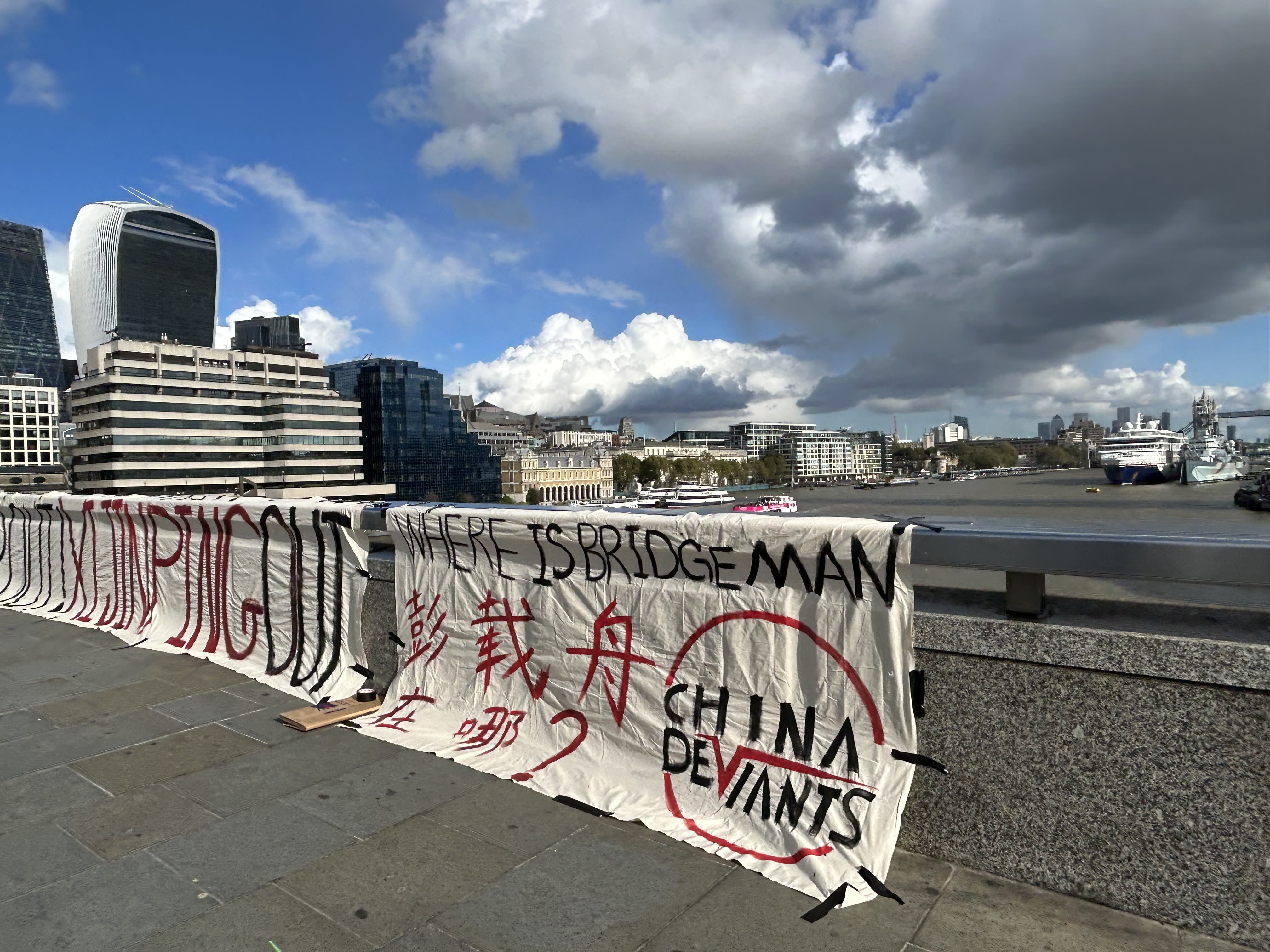 Protesters hold signs in both Chinese and English that read "Where is Bridge Man (Peng Zaizhou)?" to raise awareness of Peng's disappearance. (Chen Qi)