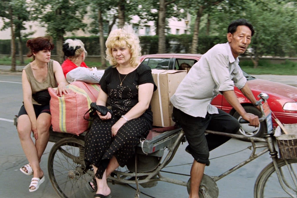 1995年6月13日，北京，俄罗斯外贸商人搭乘运送货物的三轮车。（AFP / Yoshikazu TSUNO）